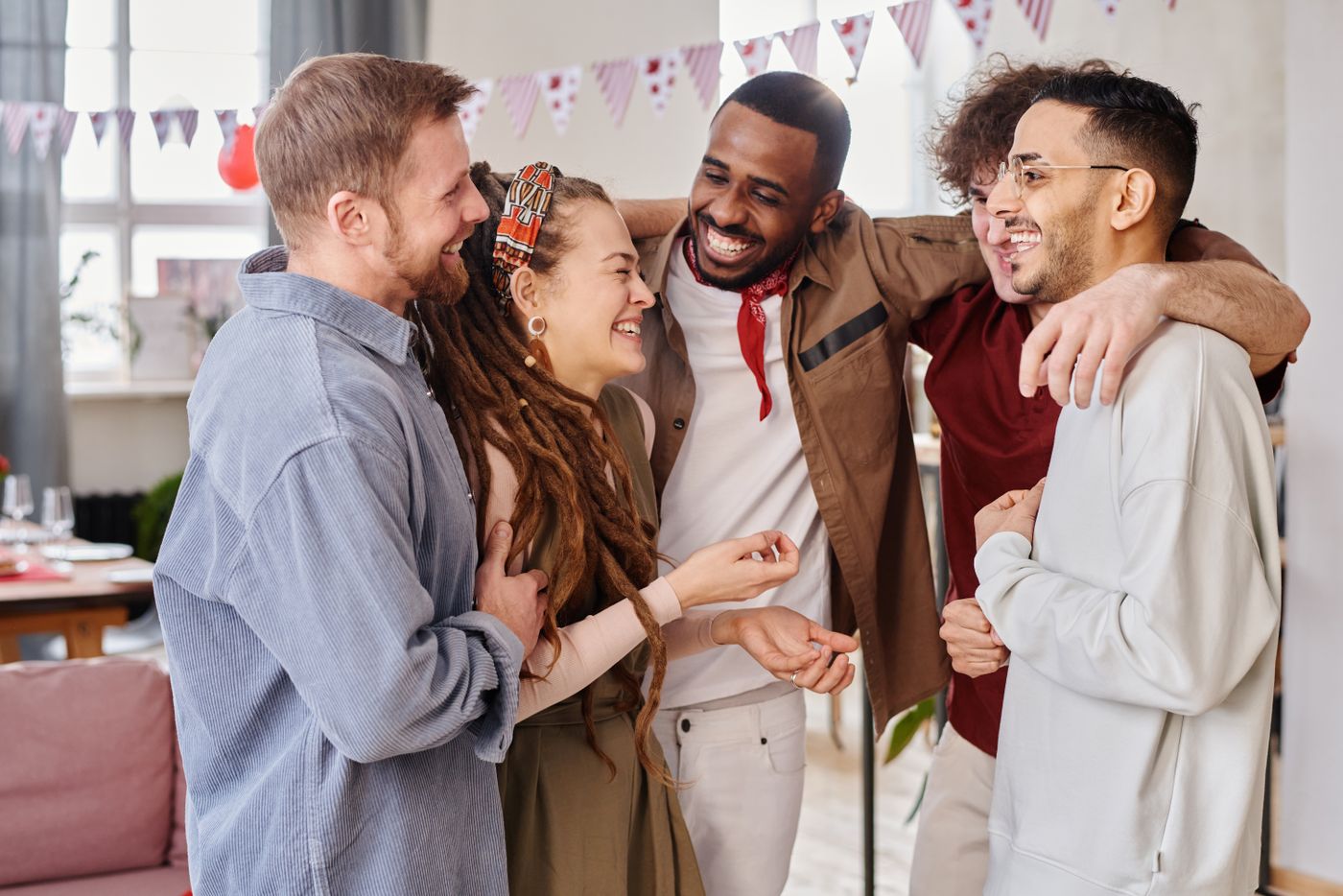 A diverse group of friends laughing together at a celebration